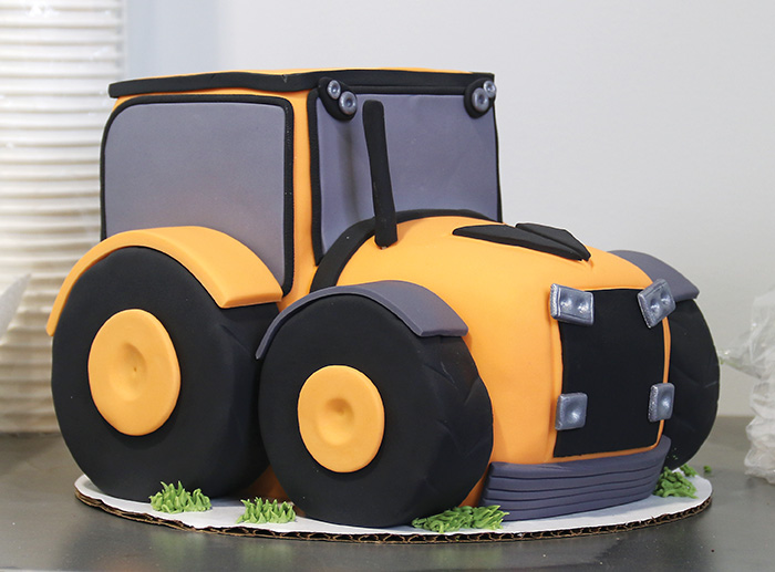The grand opening cake shaped like a tractor.<br />